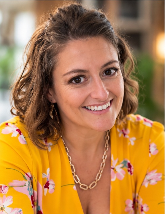BriAnn smiling in a yellow floral blouse